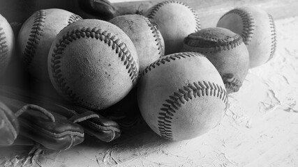 Leather old dirty baseball balls in black and white for nostalgia sports equipment background.