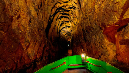 Cave. Dungeon. Silesia. Silver rush. Swimming along underground rivers. Tarnowskie Góry. Black Trout Adit. Miners of Silesia. The Green boat is underground. Underground river. River in a cave. UNESCO