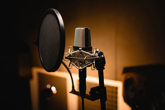 Close-up shot of a professional microphone in a recording studio