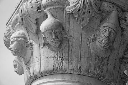Venice, Italy, Sept. 17, 2023: Medieval carvings of peoples of the world adorn a Doge’s Palace portico column, faces identified left to right as Latin, Tartar, Turk, Hungarian.