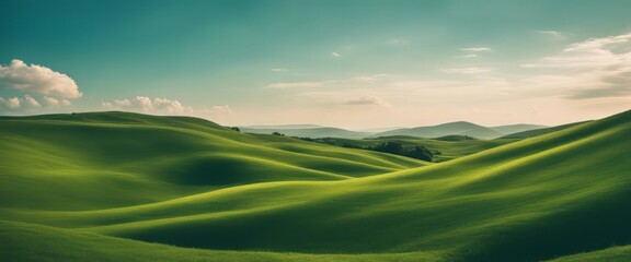 Obraz premium Idyllic Rolling Green Hills Under a Clear Blue Sky with Wispy Clouds. Tranquil Nature Landscape