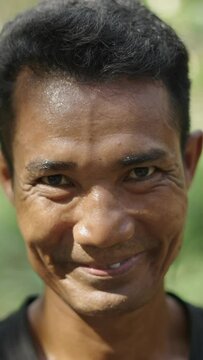 Adult asian construction worker man looking at the camera and smiles - FHD Vertical video