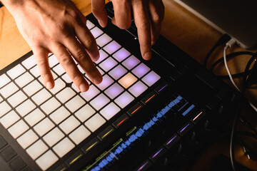 Close-up of a copper controller on a desktop, male hands pressing keys on it © fesenko