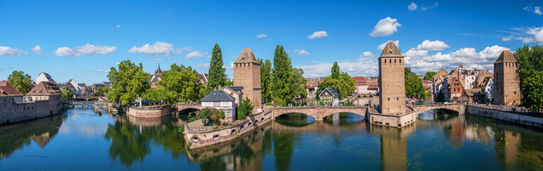 Fototapeta na wymiar Panoramic view on The Ponts Couverts in Strasbourg with blue cloudy sky. France.