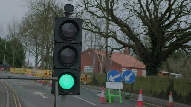 Road diversion, temporary traffic lights. Road works and traffic. 