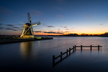 Dutch Windmill Sunset Along Lake