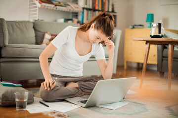 Focused Woman Working from Home on Laptop
