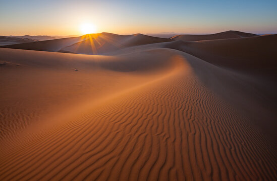 View of desert sand dunes at sunset near Ghat, Sahara desert, Libya.