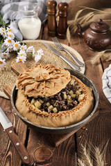 Tatar national pie balish on a wooden background