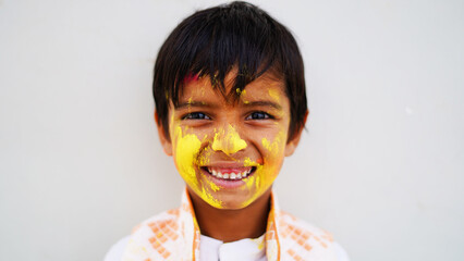Portrait of the kid, painted in the colors of Holi. India Festival of colours.