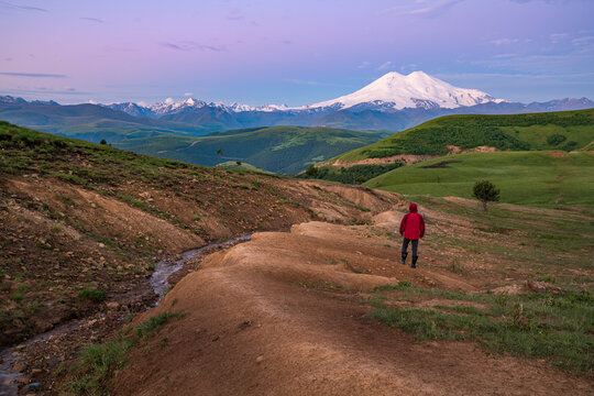 View of a person looking at the Mount Elbrus with snow on the top, Karachay-Cherkess, The Caucasus, Russia.