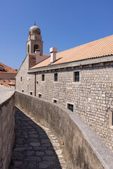 Fototapeta na wymiar City Walls with Clock tower, surrounding medieval city on the Adriatic Sea, Dubrovnik, Croatia