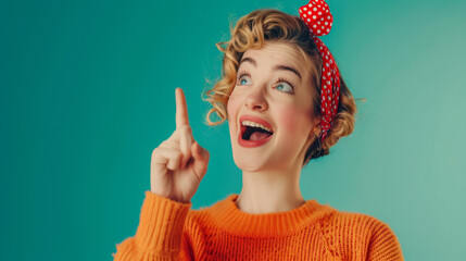 An excited woman with curly hair and a red headband points upwards, her eyes wide and mouth open in a moment of joyful realization against a teal background.