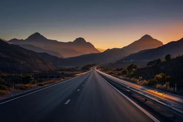 Tuinposter A road extending towards a radiant sunrise cresting over a mountain ridge, with early morning birds flying across the sky. The lighting is lively, capturing the energy of a new day. © Abdul