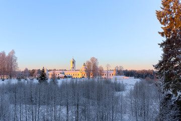 Early winter morning view of the Holy Trinity Alexander-Svirsky Monastery. The winter sun illuminates the walls of the monastery.