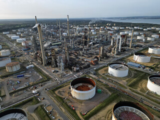 Fawley biggest oil refinery and petrochemical complex in UK with chimneys and white oil storage...