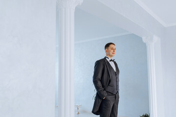 Portrait of smiling successful Caucasian man in formal suit, posing in room, happy young male boss or CEO looking at camera, showing confidence and strength, leadership concept