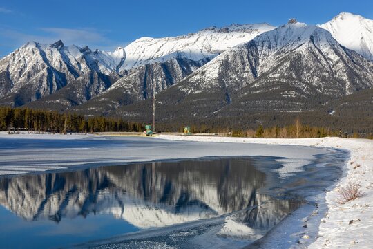 Snow Covered High Rocky Mountain Peaks Reflected in Calm Lake Water

Scenic Sunny Winter Day Landscape Panorama, Canadian Rocky Mountains Fairholme Range, Canmore Alberta Canada, Banff National Park
