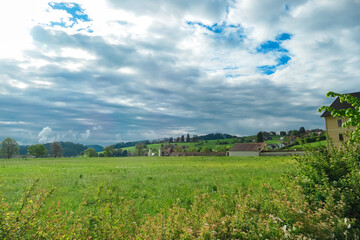 Fototapeta na wymiar Lush green meadow with scenic view of picturesque Rein Abbey in Gratwein near Graz, Steiermark, Austria. Oldest Cistercian abbey in the world. Travel destination in summer. Cradle of Styria