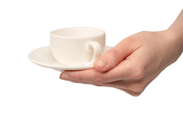 Female hand holding coffee cup and saucer isolated on white background.