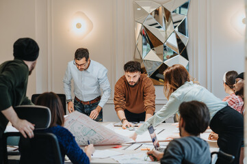 Professional group brainstorming over documents at workplace.