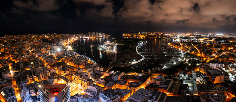 Aerial view of dense urban cityscape at night, Gzira, Malta.