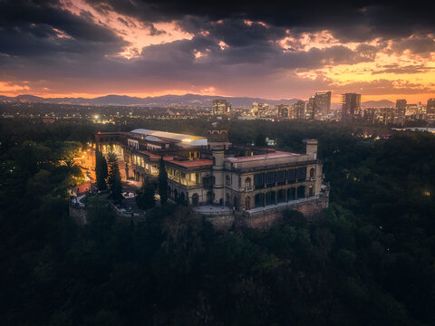 Aerial view of Chapultepec Park with Castillo de Chapultepec and city skyline at sunset, Mexico.