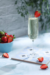 A glass of champagne with strawberries in summer style	