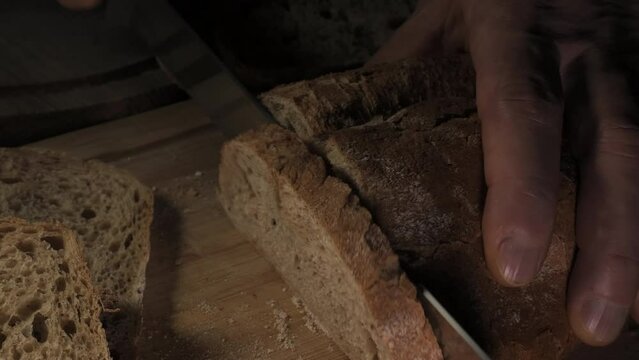 Cutting slice of homemade Crusty rye bread