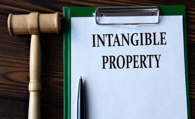 INTANGIBLE PROPERTY - words on a white sheet with a judge's gavel - obrazy, fototapety, plakaty