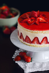 Close-up of an exquisite Fraisier cake adorned with freshly cut strawberries.
