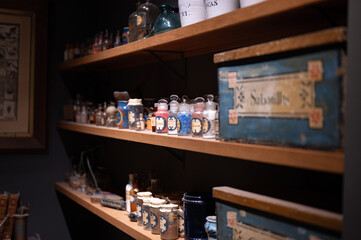 Detail of some old pharmacist shelves that contain glass jars with components, elements and medicines to prepare master recipes. Dates from 1910 in the municipal museum of Llivia - obrazy, fototapety, plakaty