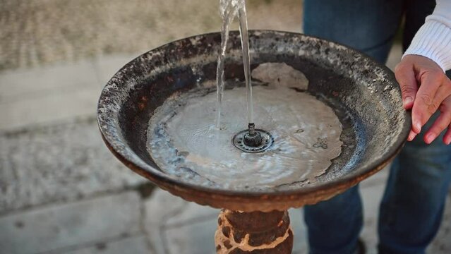 Close-up view of an old vintage drinking fountain with flowing clean fresh water