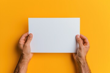 Male hands with blank sheet of paper on colorful background