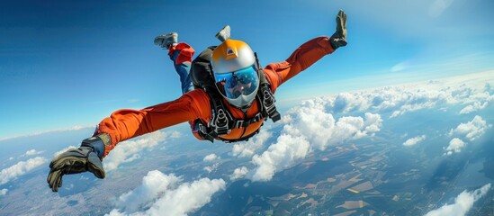 A man in an orange suit is in freefall high up in the air, with no parachute deployed.