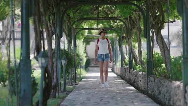Tourist woman visiting Achilleion palace in Gastouri on Corfu island, Greece, slow motion