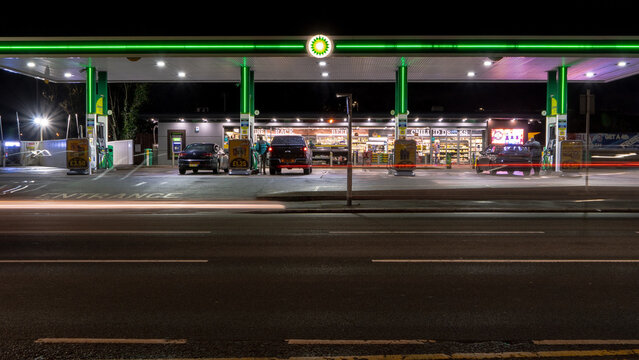 A BP petrol station forecourt with passing traffic. Stourbridge, UK - February 20, 2024