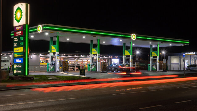 A BP petrol station forecourt with passing traffic. Stourbridge, UK - February 20, 2024