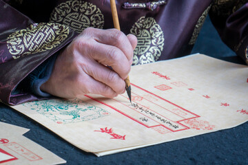 a calligrapher with delicate handwriting. Writing brush, chinese calligraphy image. 