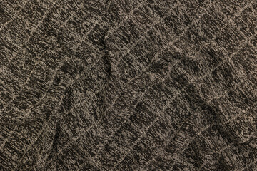 Dark wool fabric with a pattern. Fabric background.