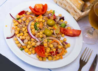 Salad with tomatoes, olives with garbanzos and onion in restaurante