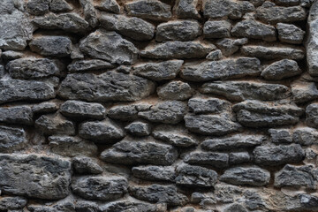 Fragment of an ancient stone wall. Close-up photo