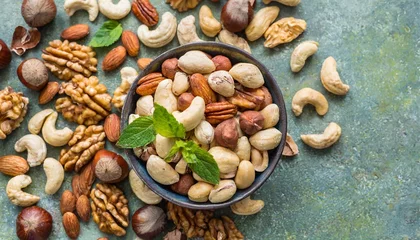 Crédence de cuisine en verre imprimé Brésil mixed nuts in bowl mix of various nuts on colored background pistachios cashews walnuts hazelnuts peanuts and brazil nuts