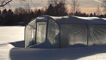 Greenhouse in snow, Planter house in winter.