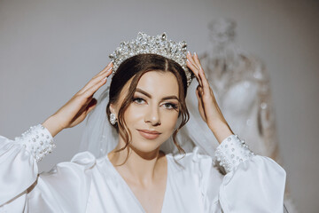 Luxury wedding crown diadem on bride's head hairstyle.Portrait. Morning wedding preparation bride...