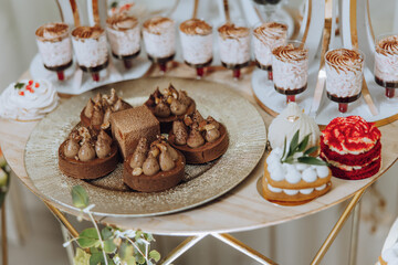 Almond cookies, sweet cakes for a wedding banquet. A delicious reception, a luxurious ceremony. Table with sweets and desserts. Delicious colorful French desserts on a plate or table. Candy bar.