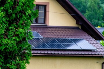 Historic farm house with modern solar panels on roof and wall