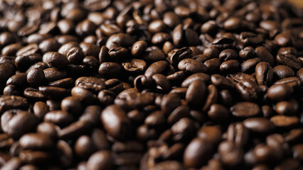 Aromatic coffee beans close-up. Grain inspection. A large amount of coffee