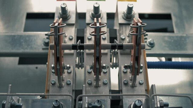 Movement of contactors and relays under high voltage inside the power distribution cabinet in the electrical room. Close-up 