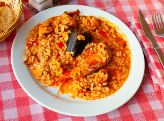 Appetizing racy seafood paella with mussels and prawns.Traditional Valencian cuisine